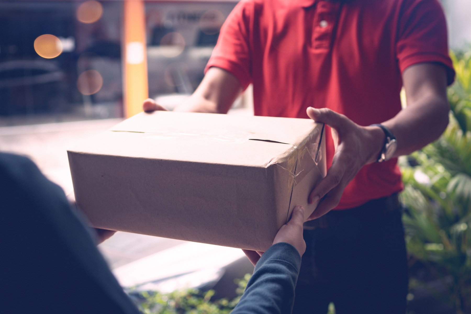 Delivery Person Handing Out Parcel to Customer